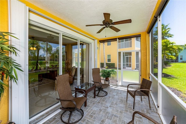 sunroom / solarium featuring ceiling fan