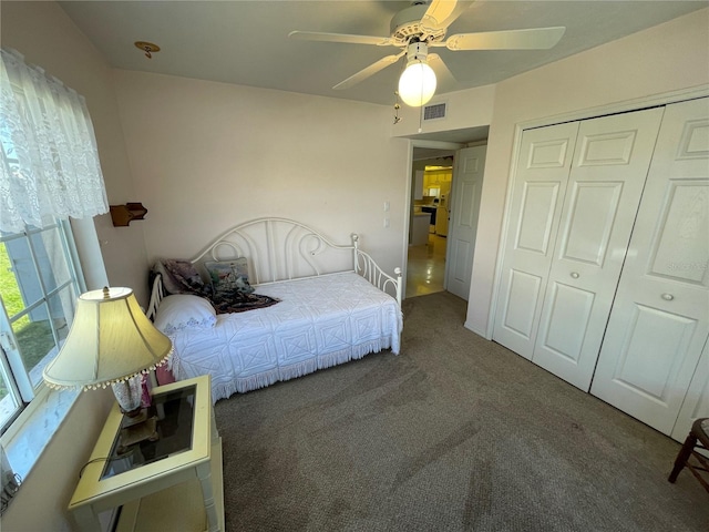 carpeted bedroom with a closet and ceiling fan