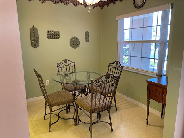 dining space featuring light tile patterned flooring