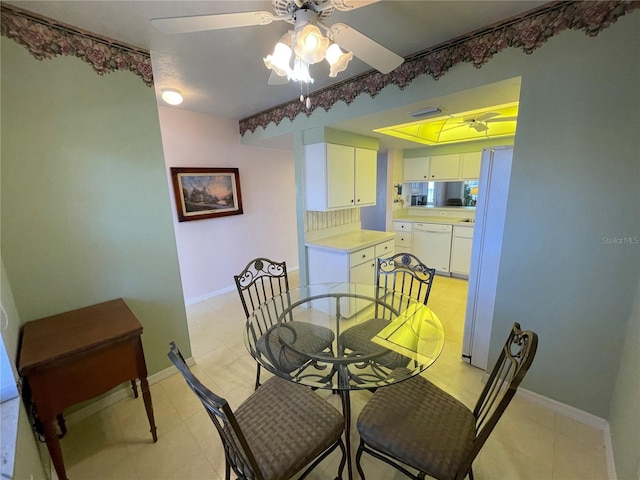 dining space with ceiling fan and light tile patterned floors