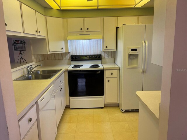 kitchen featuring sink, premium range hood, white appliances, and light tile patterned floors