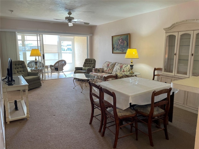 dining area featuring ceiling fan and carpet floors