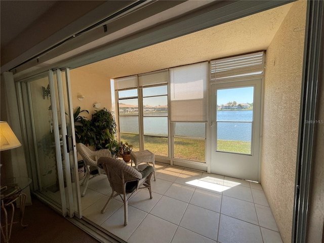 sunroom / solarium with a water view