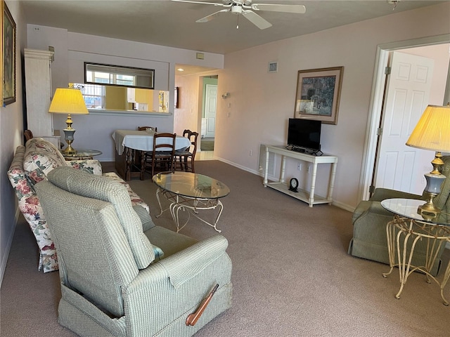 carpeted living room with ceiling fan