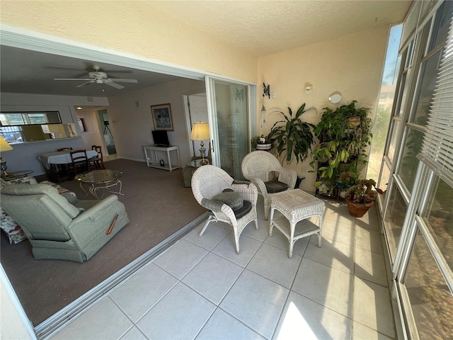 interior space with ceiling fan and a patio area