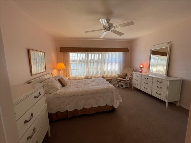 bedroom featuring dark colored carpet and ceiling fan