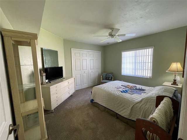 bedroom with a closet, ceiling fan, and dark colored carpet