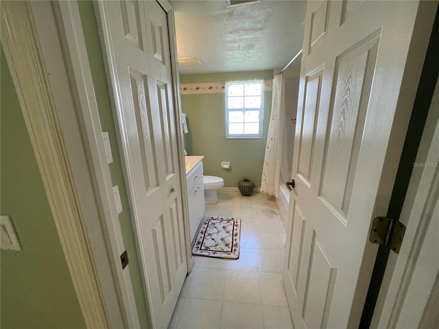 bathroom with tile patterned flooring, toilet, a shower with shower curtain, and vanity