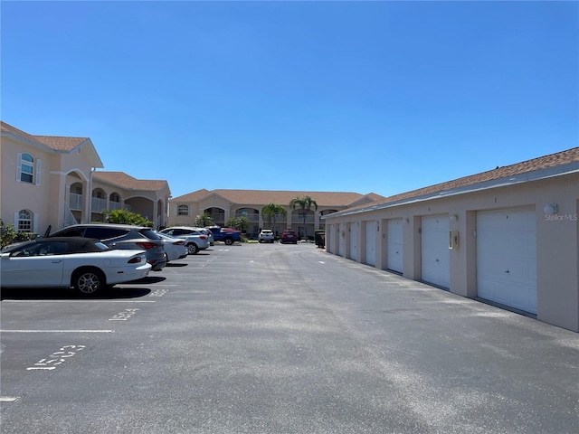 view of car parking featuring a garage