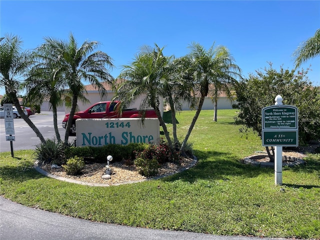 community sign featuring a yard