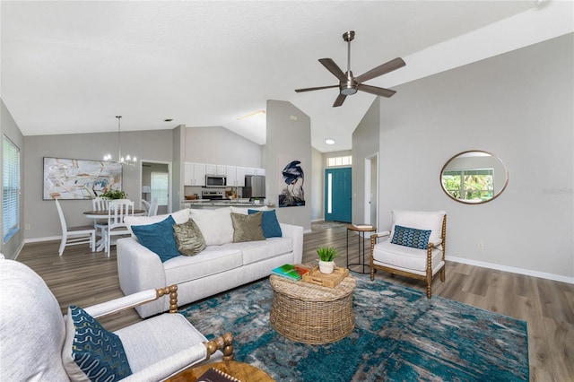 living room featuring ceiling fan with notable chandelier, high vaulted ceiling, and hardwood / wood-style floors