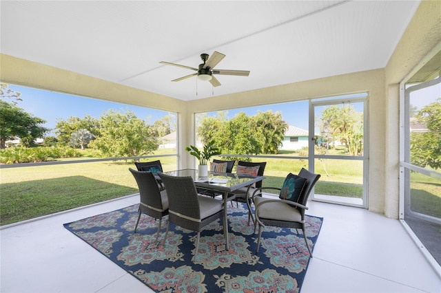 sunroom / solarium featuring ceiling fan