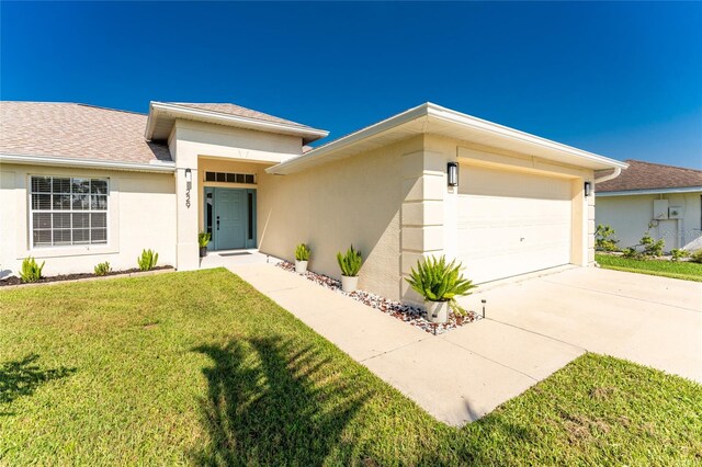 view of front of home featuring a garage and a front yard