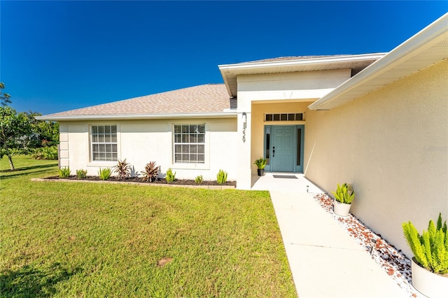 property entrance with a yard