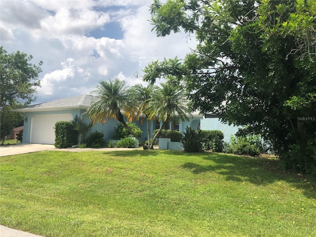 view of front of home with a garage and a front yard