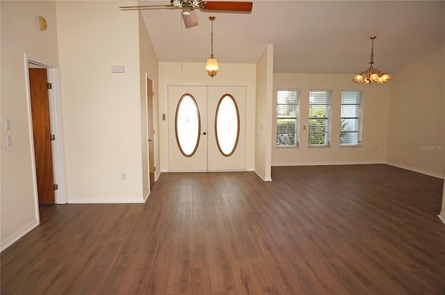 entrance foyer with french doors, high vaulted ceiling, dark hardwood / wood-style flooring, and ceiling fan with notable chandelier