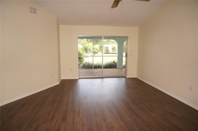 spare room featuring ceiling fan and dark wood-type flooring