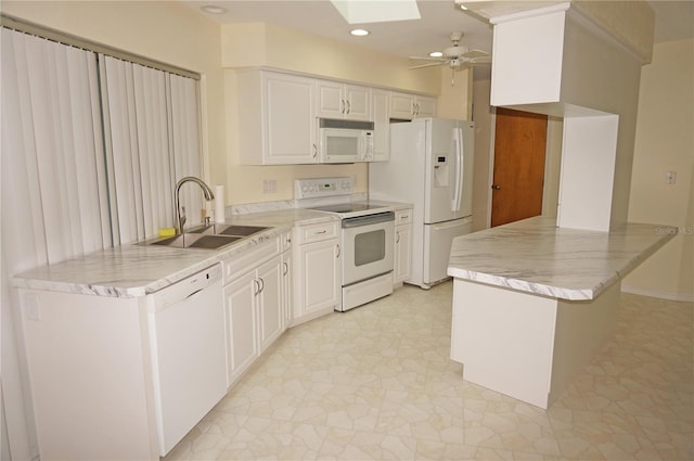 kitchen featuring sink, white appliances, ceiling fan, and light tile patterned floors