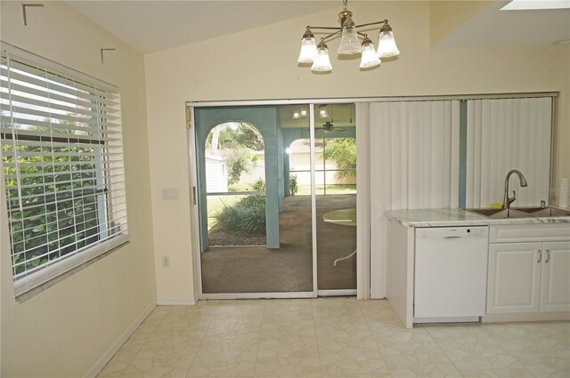 doorway to outside with sink, lofted ceiling, light tile patterned flooring, and a chandelier