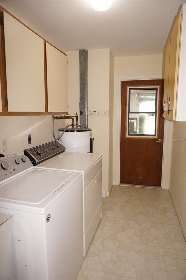 laundry area featuring water heater, cabinets, and separate washer and dryer