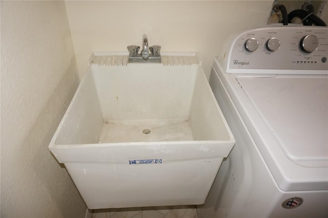 clothes washing area featuring sink, tile patterned flooring, and washer / clothes dryer