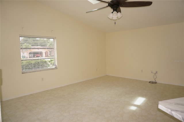 tiled empty room featuring ceiling fan and lofted ceiling