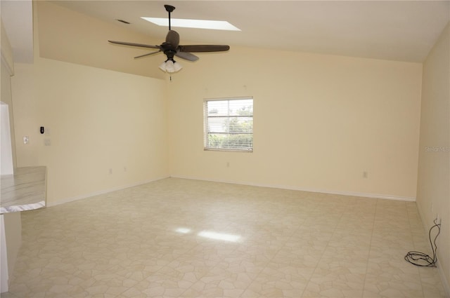 unfurnished room with ceiling fan and vaulted ceiling with skylight