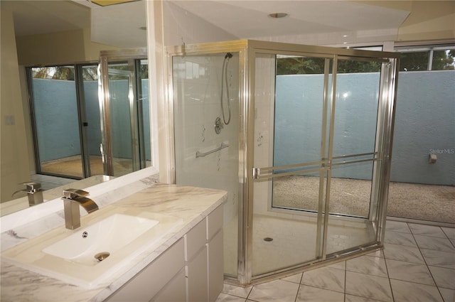 bathroom with tile patterned flooring, vanity, and a shower with shower door