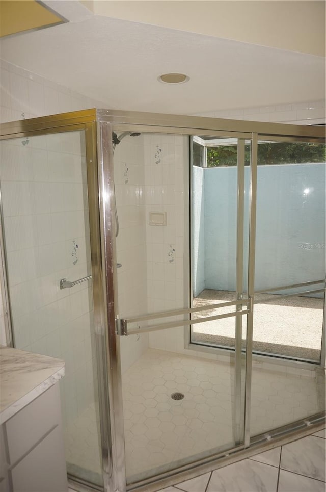 bathroom with tile patterned floors and a shower with shower door