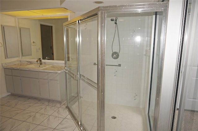 bathroom with a shower with shower door, tile patterned flooring, and vanity