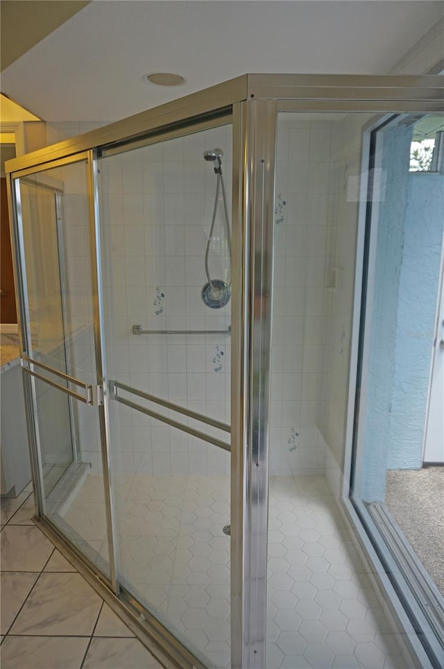 bathroom featuring tile patterned floors, vanity, and walk in shower