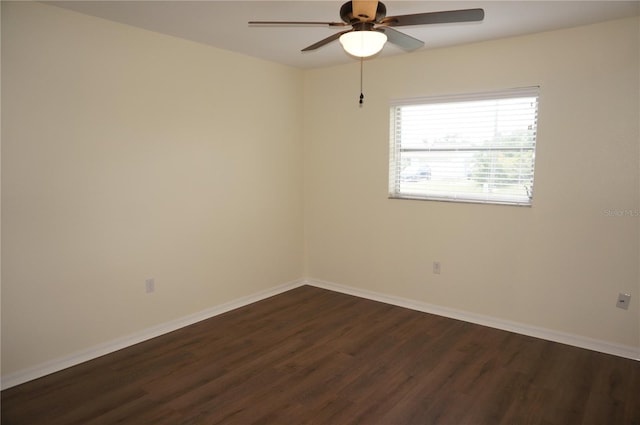 spare room with dark hardwood / wood-style flooring and ceiling fan