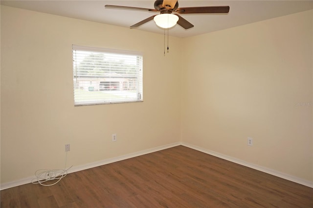 unfurnished room with ceiling fan and dark wood-type flooring