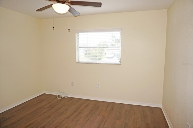 empty room with dark hardwood / wood-style flooring and ceiling fan