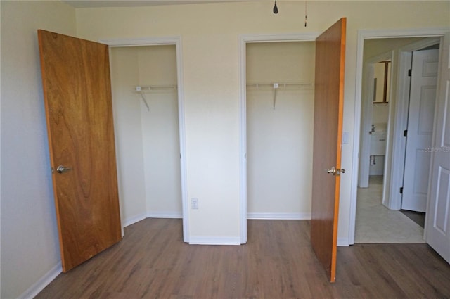 unfurnished bedroom with a closet and hardwood / wood-style floors