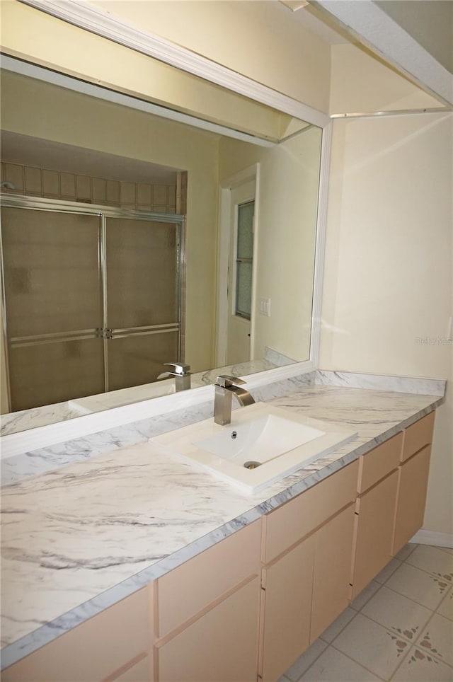 bathroom featuring tile patterned flooring and vanity