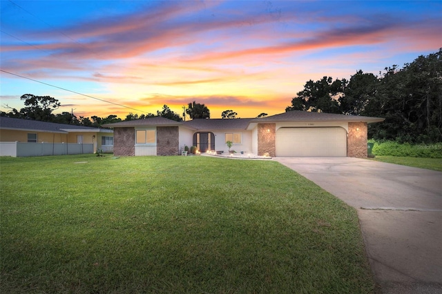 view of front of property with a yard and a garage