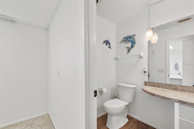 bathroom featuring toilet and hardwood / wood-style flooring