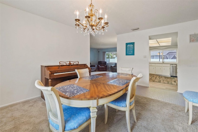 carpeted dining space with an inviting chandelier