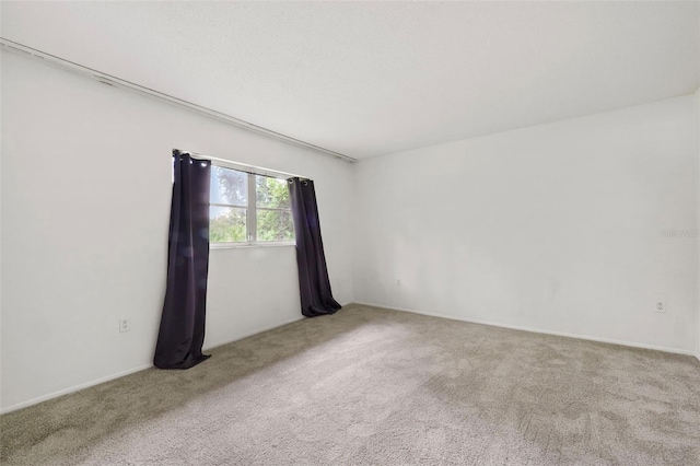 spare room with light colored carpet