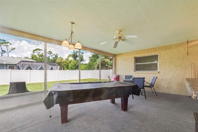 game room featuring ceiling fan, a wealth of natural light, carpet, and a textured ceiling