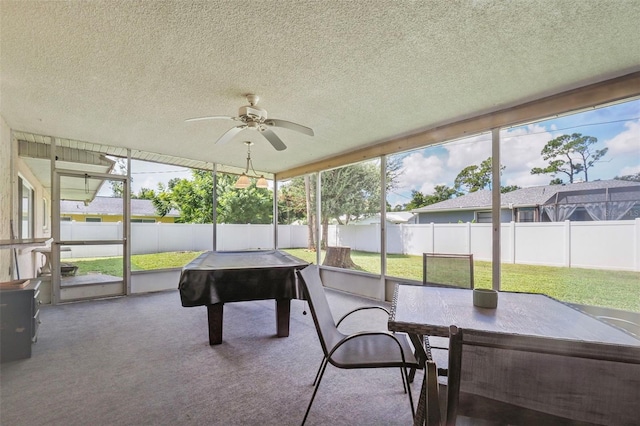 sunroom featuring ceiling fan