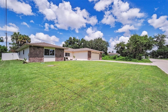 ranch-style house featuring a front yard and a garage