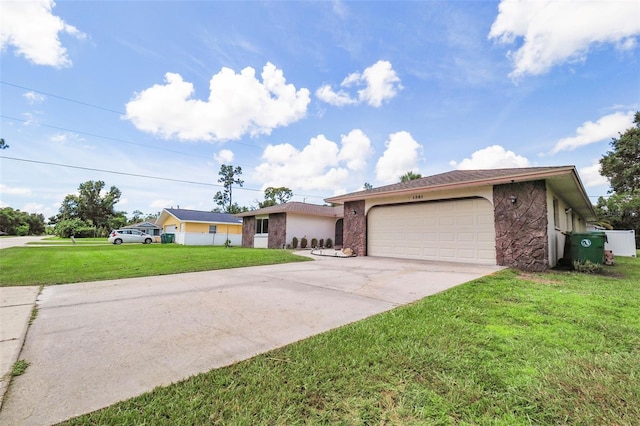 ranch-style house featuring a front yard and a garage