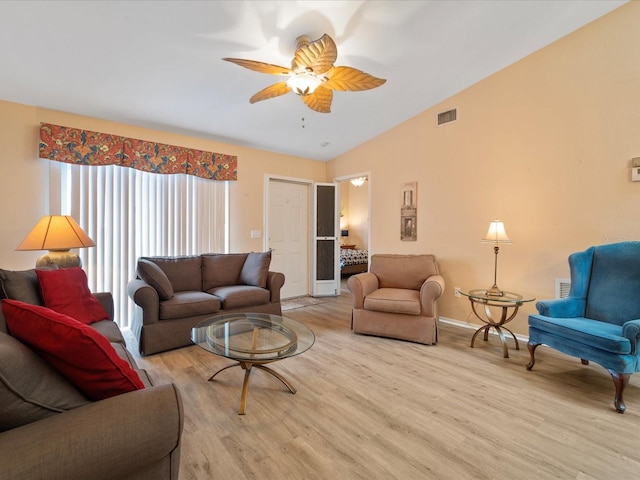 living room with light hardwood / wood-style flooring, ceiling fan, and lofted ceiling