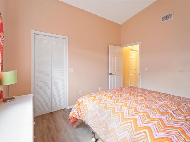 bedroom with a closet and light hardwood / wood-style floors