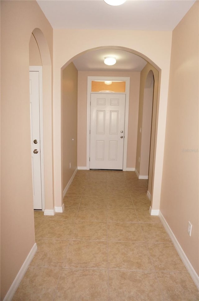 hall with light tile patterned floors