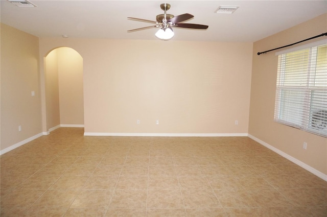 spare room with ceiling fan and light tile patterned floors