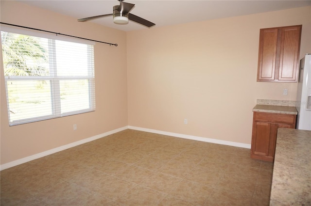 empty room featuring ceiling fan and light tile patterned floors