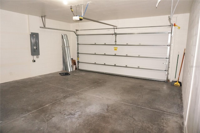 garage with a garage door opener and electric panel